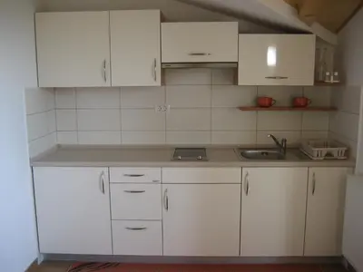 a kitchen with white cabinets and a sink at Turistična kmetija Pri Rebkovih in Ajdovščina