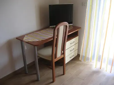 a desk with a chair and a computer monitor at Turistična kmetija Pri Rebkovih in Ajdovščina