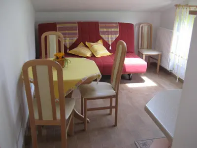 a small room with a table and a bed at Turistična kmetija Pri Rebkovih in Ajdovščina