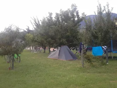 a tent in a field next to some trees at Turistična kmetija Pri Rebkovih in Ajdovščina