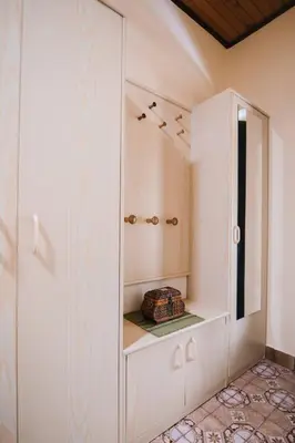 a white cabinet in a room with a shelf at Apartment Skala with Magnificent view in Rečica ob Savinji