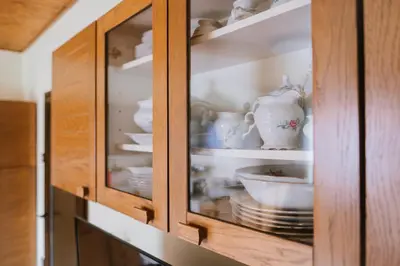a cabinet filled with plates and bowls and dishes at Apartment Skala with Magnificent view in Rečica ob Savinji