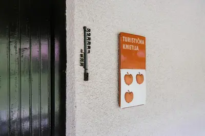a sign on a wall next to a door at Apartment Skala with Magnificent view in Rečica ob Savinji