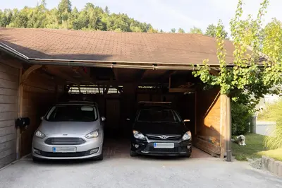 two cars are parked in a garage at Studio Apartment Jož' in Spodnja Lipnica