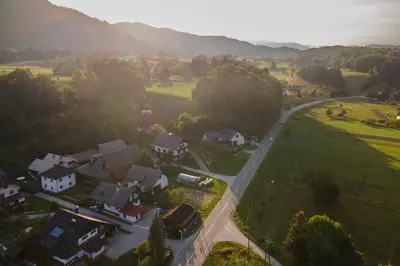 an aerial view of a village with houses and a road at Studio Apartment Jož' in Spodnja Lipnica