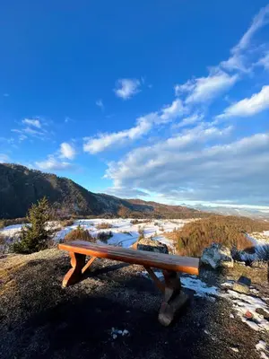 a wooden bench sitting on top of a mountain at Studio Apartment Jož' in Spodnja Lipnica