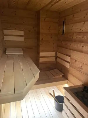 an empty sauna with wooden walls and wooden floors at Apartment on the ski slope Pohorje 11 in Pohorje