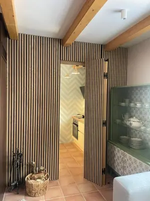 a kitchen with striped walls and a room with a counter at Apartment on the ski slope Pohorje 11 in Pohorje