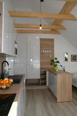 a kitchen with white cabinets and a wooden counter top at Apartments Ajda in Bohinj
