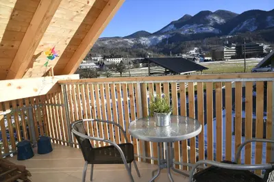 a table and chairs on the balcony of a cabin at Apartments Ajda in Bohinj