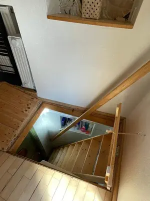 an overhead view of an attic with a staircase with wooden floors at Super Small Micro-Treehouse in the centre in Ljubljana
