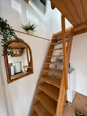 a staircase in a house with a mirror at Super Small Micro-Treehouse in the centre in Ljubljana