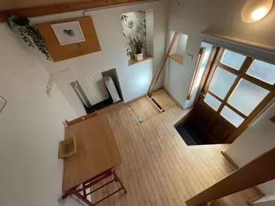 an overhead view of a living room with a wooden table at Super Small Micro-Treehouse in the centre in Ljubljana