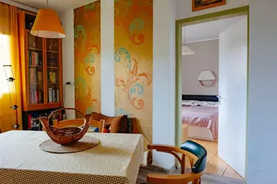 a dining room with a table and a bedroom at Comfy and central with bikes in Bohinj