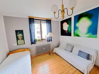 a living room with two beds and a couch at Comfy and central with bikes in Bohinj