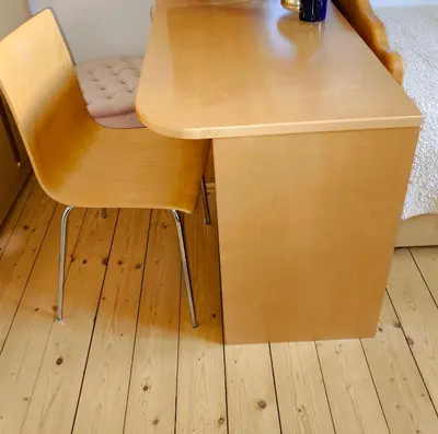 a wooden table with a chair next to a desk at Comfy and central with bikes in Bohinj