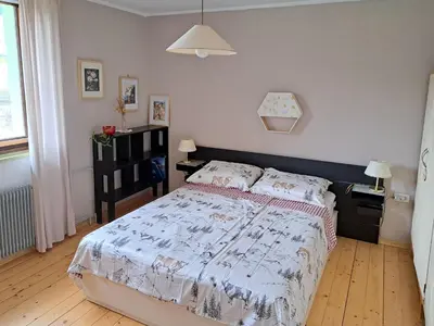 a bedroom with a large bed in a room at Comfy and central with bikes in Bohinj