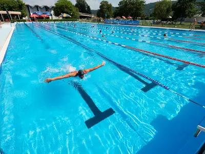 a person swimming in a swimming pool at Glamping Terme Čatež in Brežice
