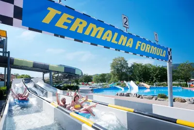 a group of people riding down a water slide at a water park at Glamping Terme Čatež in Brežice