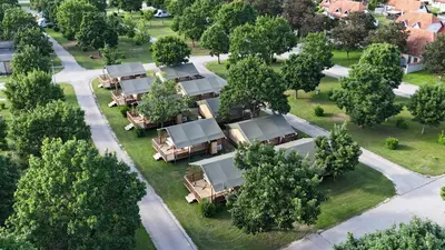 an aerial view of a resort with trees and tables at Glamping Terme Čatež in Brežice