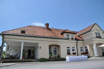 a large white building with a red roof at Gostišče - Guest house STARI HRAST in Ljutomer