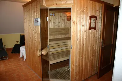 a wooden closet with a glass door in a room at Gostišče - Guest house STARI HRAST in Ljutomer