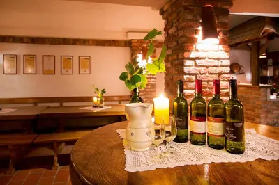 a group of wine bottles and glasses on a table at Gostišče - Guest house STARI HRAST in Ljutomer