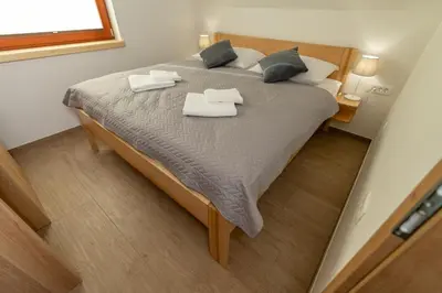 a bedroom with a large bed with towels on it at Apartment Orehar in Bohinj