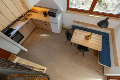 an overhead view of a small kitchen with a table and chairs at Apartment Orehar in Bohinj