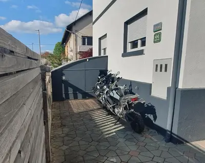 a motorcycle parked in a garage next to a building at Ljubljana apartment in Ljubljana