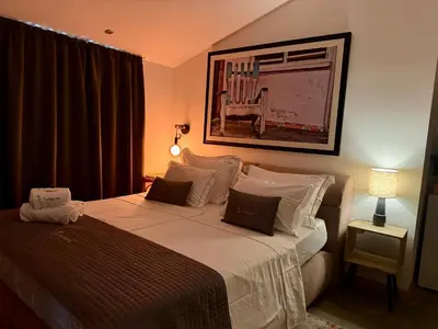 a bedroom with a large bed with a picture on the wall at La Cubanita in Kojsko