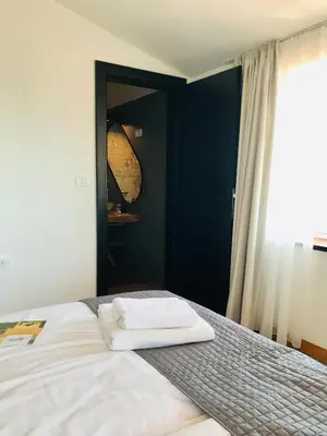 a bedroom with a bed with two towels on it at La Cubanita in Kojsko