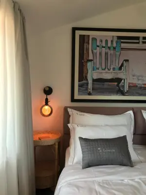 a bedroom with a bed and a picture of a chair at La Cubanita in Kojsko