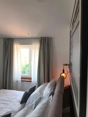 a bedroom with a bed with white pillows and a window at La Cubanita in Kojsko