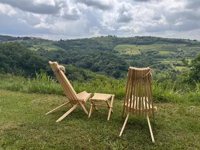 two wooden chairs sitting on top of a field at La Cubanita in Kojsko