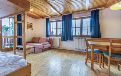 a bedroom with a bed and a desk and a table at Stunning Apartment In Pohorje With Wifi in Pohorje