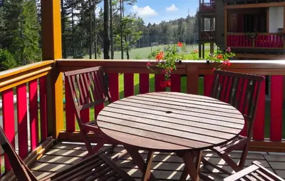 a wooden table and two chairs on a porch at Stunning Apartment In Pohorje With Wifi in Pohorje
