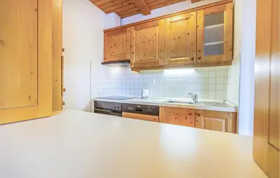 a kitchen with wooden cabinets and a counter top at Stunning Apartment In Pohorje With Wifi in Pohorje