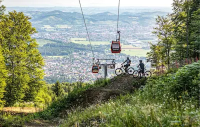 two people on bikes on a hill with a ski lift at Stunning Apartment In Pohorje With Wifi in Pohorje