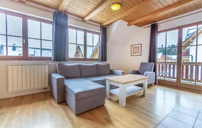 a living room with a couch and a table at Stunning Apartment In Pohorje With Wifi in Pohorje