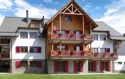 a large wooden house with red balconies at Awesome Apartment In Pohorje With Wifi in Pohorje