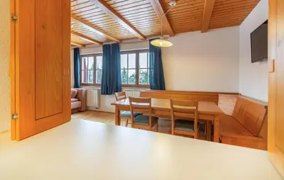 a kitchen and dining room with a table and chairs at 1 Bedroom Gorgeous Apartment In Pohorje in Pohorje