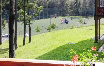 a group of people playing tennis on a tennis court at Awesome Apartment In Pohorje in Pohorje