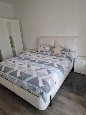 a bedroom with a bed with a checkered comforter at apartma-sobe Lejla in Vipava