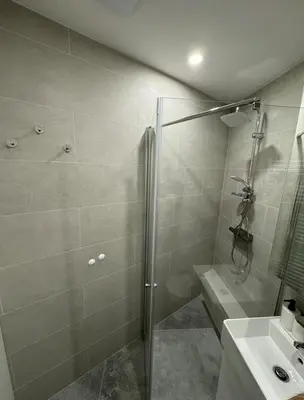 a bathroom with a shower and a sink and a glass shower stall at Apartma Tisa Bohinj-no outside windows in Bohinj