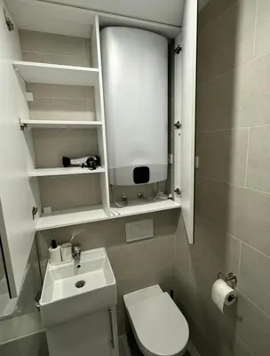 a small bathroom with a toilet and a sink at Apartma Tisa Bohinj-no outside windows in Bohinj