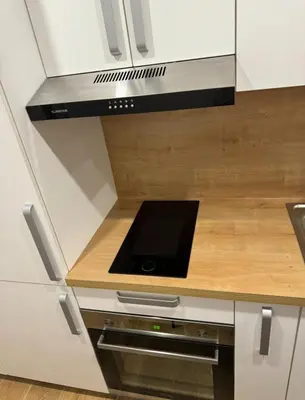 a small kitchen with a stove and a microwave at Apartma Tisa Bohinj-no outside windows in Bohinj