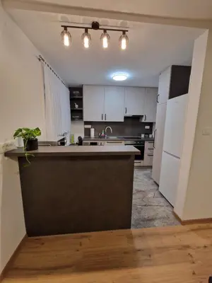 a kitchen with white cabinets and a counter top at Vila Lastovka in Ljubljana