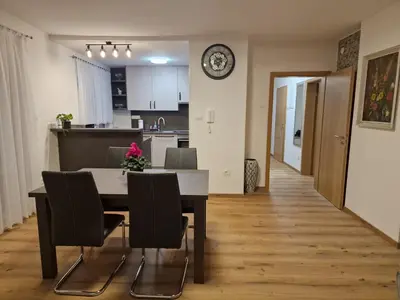 a kitchen and dining room with a table and chairs at Vila Lastovka in Ljubljana