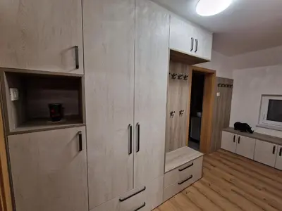 a kitchen with white cabinets in a room at Vila Lastovka in Ljubljana